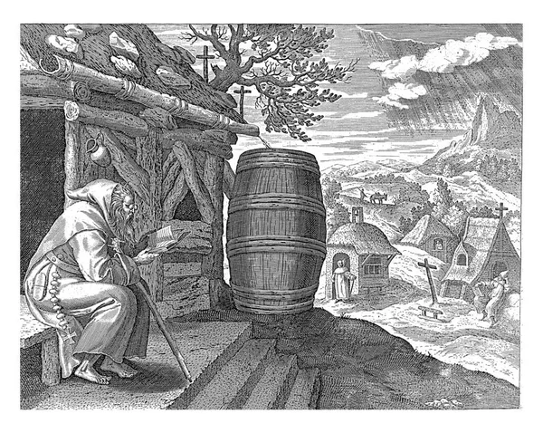 圣安莫尼乌斯大帝穿着僧袍他坐在小木屋前的长椅上 读圣经 背景是一个隐士的村庄 — 图库照片