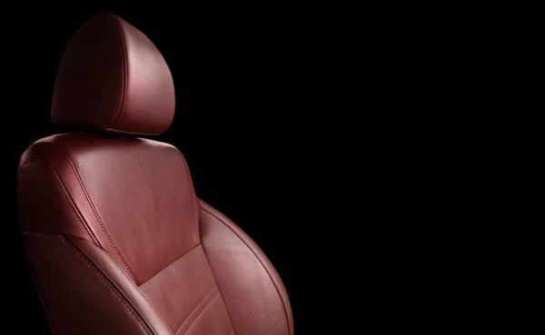 Modern luxury car red leather with alcantara interior. Part of red leather car seat details with white stitching. Interior of prestige car. Perforated leather seats isolated. Perforated leather.