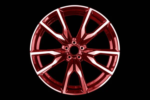 Red car alloy wheel isolated on black background. New alloy wheel for a car on a black background. Alloy rim isolated. Car wheel disc.