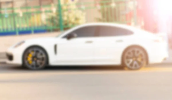 Blurred background with cars on the street. Bokeh lights background. Abstract blur car parking lot for background. Blurred cars parking. Bokeh light