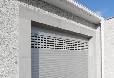 Roller shutter gate. Metal roller garage door as background. Automatic electric roll-up garage gate. Garage with rolling gates.