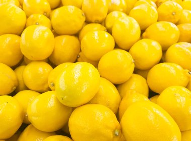 Ripe whole yellow lemon citrus fruit texture background. Fresh lemon fruit pattern.