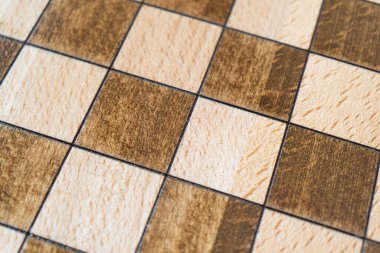 Empty wooden chessboard pattern. Top view. Board made of wood for playing chess. Chessboard texture background.