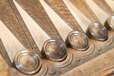 Closeup of backgammon board game. Wooden backgammon board with checkers and dice pair