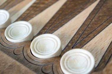 Closeup of backgammon board game. Wooden backgammon board with checkers and dice pair