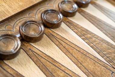 Closeup of backgammon board game. Wooden backgammon board with checkers and dice pair