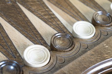 Closeup of backgammon board game. Wooden backgammon board with checkers and dice pair