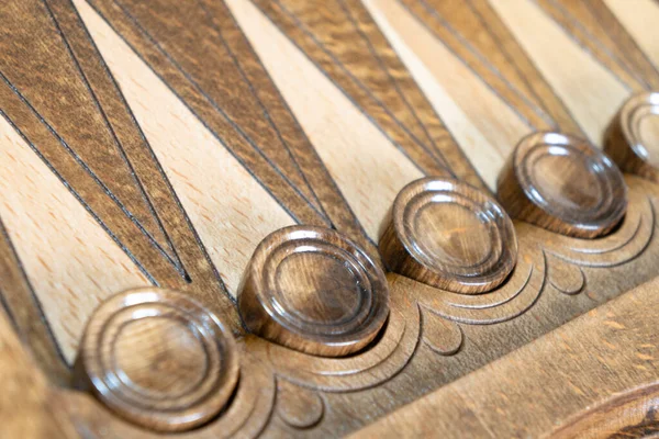 Closeup of backgammon board game. Wooden backgammon board with checkers and dice pair