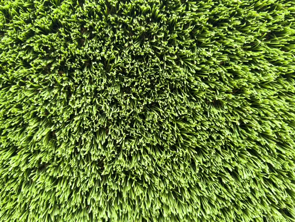 Artificial grass lawn texture. Artificial Turf Background. Greening with an artificial grass. Artificial turf laying background texture. Synthetic grass layer