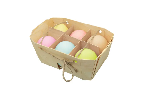 Easter eggs in wooden box isolated on white background. Rainbow colored Easter eggs isolated. Group of easter eggs in a row.
