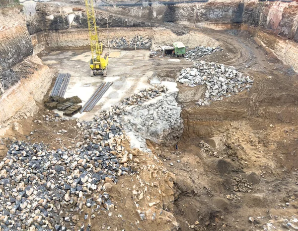 Aerial view construction site with a foundation pit of complex. pit foundation for building construction. Earthwork in excavation and backfilling of soil. Construction machinery for earthmoving