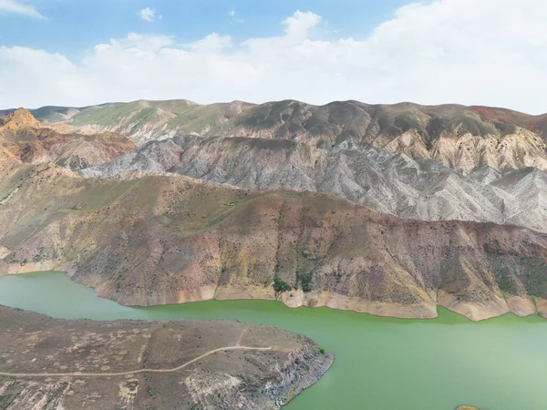 stock image Aerial view on mountain lake. Drone over water reservoir at mountain valley. Beautiful view from above on smooth blue surface of mountain lake among highlands. Azat reservoir