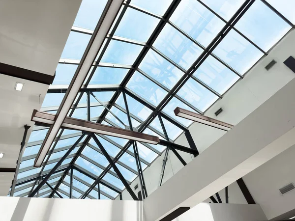 stock image Lights and ventilation system in long line on ceiling of the  industrial building. Exhibition Hall. Ceiling factory construction