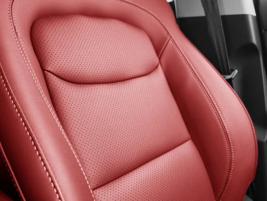 Kırmızı lüks modern araba. Modern araba iç dekorasyonunun ayrıntıları. Kırmızı deri koltukların bir kısmı pahalı arabalara dikilmiş.