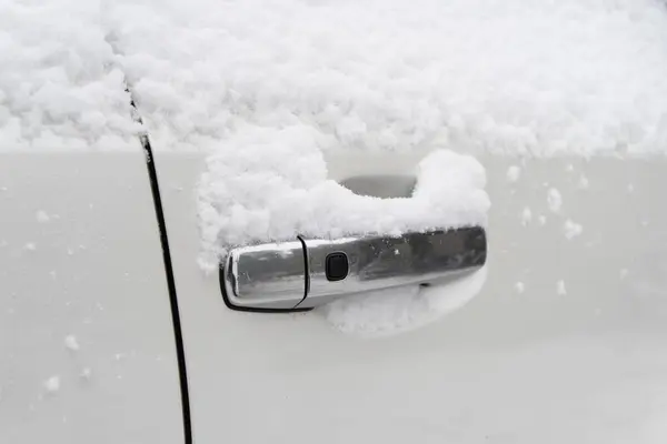 Frozen car. Car covered with snow and frost. Part of the car under snow after a heavy snowfall. The body of the car is covered with snow after blizzard