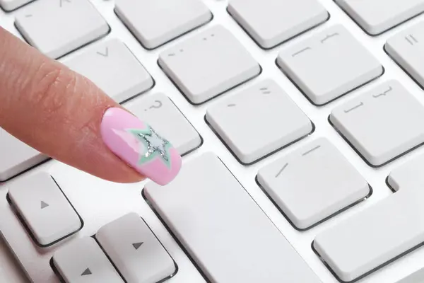 Close up view of a Finger Pushing on a empty Button of computer Keyboard. Finger Pressing a Slim Aluminum Keyboard Button. Modern Laptop Keyboard. Empty space for text