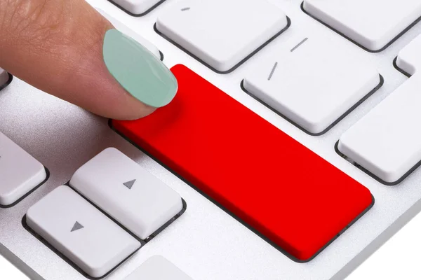 Close up view of a Finger Pushing on a red Button of computer Keyboard. Finger Pressing a Slim Aluminum Keyboard Button. Empty space for text