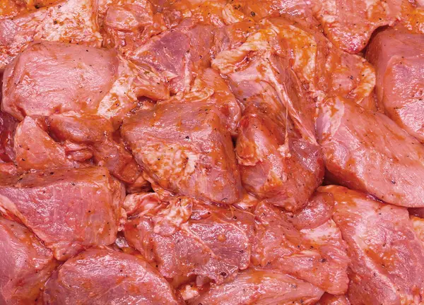 Marinated beef or pork or chicken meat background. Meat background. Marinating meat with spices. Pieces of pork or beef meat for barbecue marinated in spices