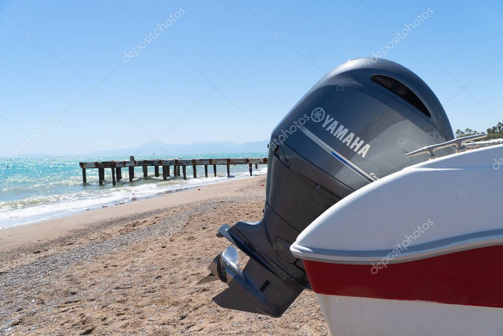 Antalya, Turkey, May 5, 2024:  Modern fishing sport boat with a brand new Yamaha 150 FourStroke outboard engine. Yamaha sign. Yamaha logo