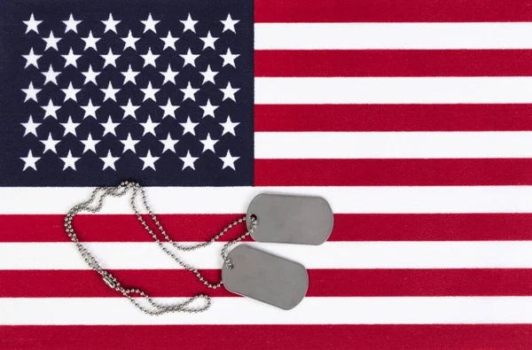 United States flag with ID or dog tags for Independence, Veterans or Memorial Day holiday concept