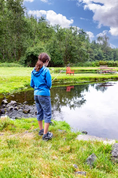 夏日明媚的时候 小女孩在池塘里钓鱼 — 图库照片