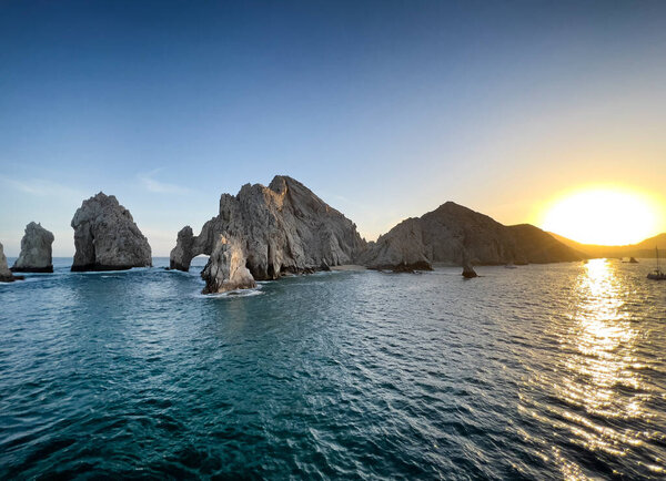 The arches in Cabo Mexico during a fading golden sunset 
