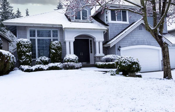 初春的暴风雪 家里和前院都覆盖着白雪 免版税图库照片