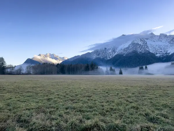 Farmland view of the Cascade mountains in Washington state during early winter season with fresh snow on mountains 