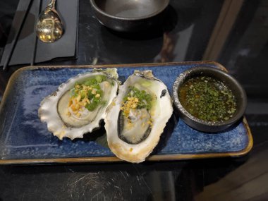 Taze istiridyelerin açık ve akşam yemeği masasında yenmeye hazır görüntüsünü kapatın. 