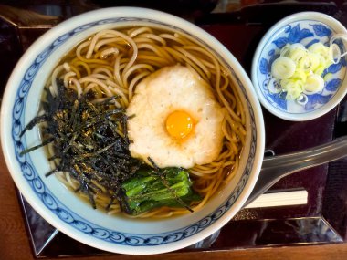 Udon şehriye çorbası, bıldırcın yumurtası, yosun ve ıspanak.  