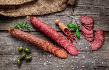 Best quality italian salami on old wooden table. Salami. Dried organic salami sausage or spanish chorizo