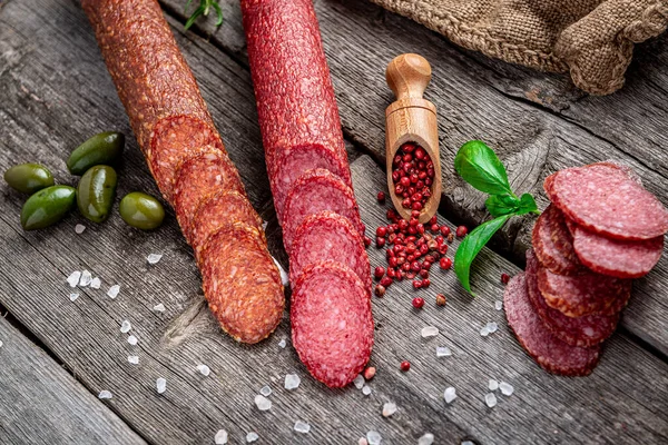 Best quality italian salami on old wooden table. Salami. Dried organic salami sausage or spanish chorizo