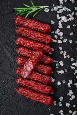 Smoked sausages of the highest quality.. Top view. On a black background.