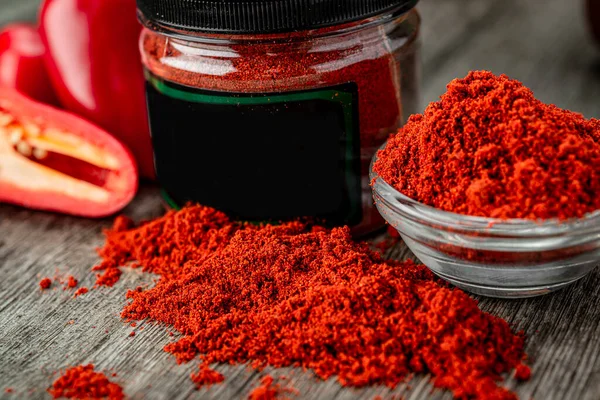 Dried red paprika poured into a box for sale. Dried spices. Photo for advertising
