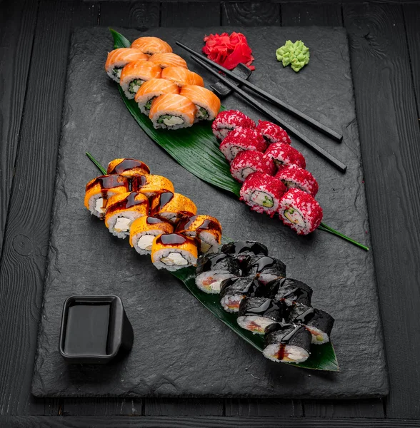 stock image Assorted sushi nigiri and maki big set on slate. A variety of Japanese sushi with tuna, crab, salmon, eel and rolls. Top view. Asian cuisine. Photo for the menu.