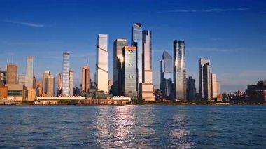 New York, ABD, 8 Temmuz 2025: Güneşli bir günde mavi nehir manzarası. Gün batımında New York, ABD 'nin ufuk çizgisinde alçak açı.