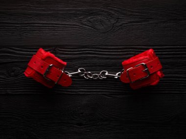 BDSM background with bright red fluffy handcuffs and rope for tying clipart