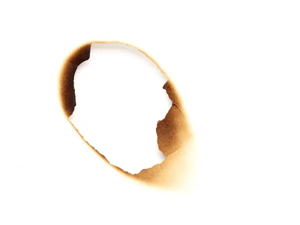 白い背景に隔離された焼かれた紙の穴 ロイヤリティフリーのストック写真