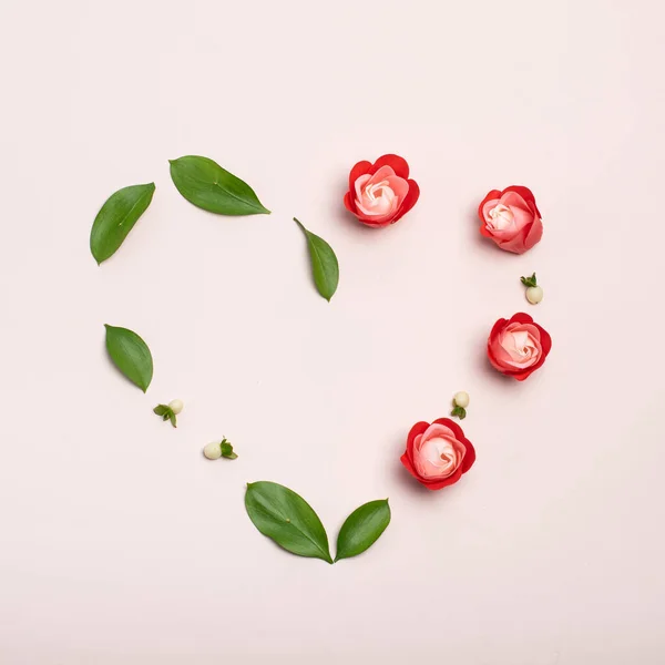 Red soap flowers on pink background top view. Simple modern, minimal flowers concept. Airy and light. Trendy floral minimalism. Flat lay image with copy space