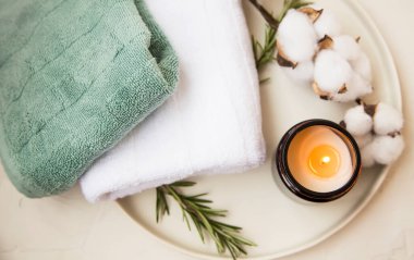 Spa setting with candle, cotton towels, wellness and spa setting still life
