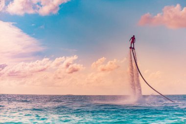 Man riding flyboard in the sea, active vacation concept