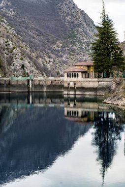 Appenines mountains peaks, the lake and the dam on Sagittarius Gorges, Abruzzo, Italy