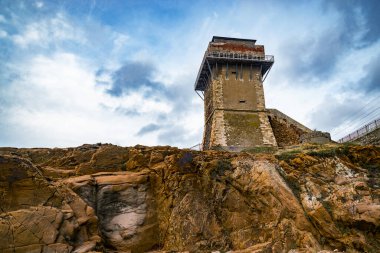 Calafuria Tower landmark on cliff rock and sea in winter. Livorno, Tuscany, Italy, Europe clipart