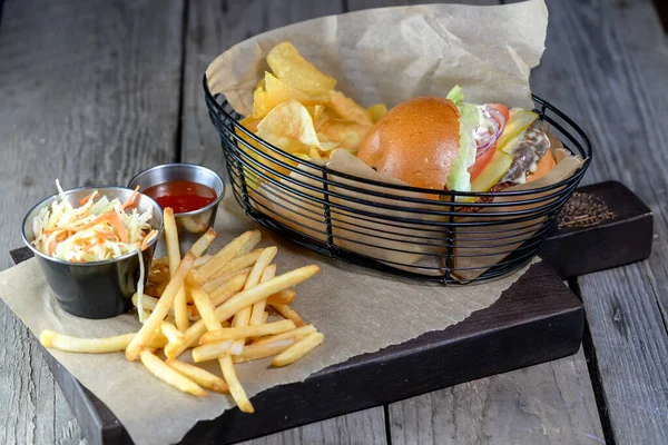 burger with  french fries,chips on background, close up