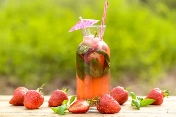 cocktail with strawberries and mint  on background, close up