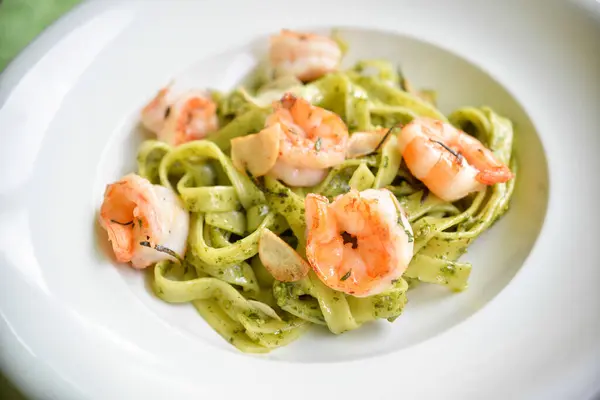 pasta with shrimps on plate on  background close up