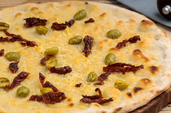 Peynirli, zeytinli ve ançüezli İtalyan pizzası.