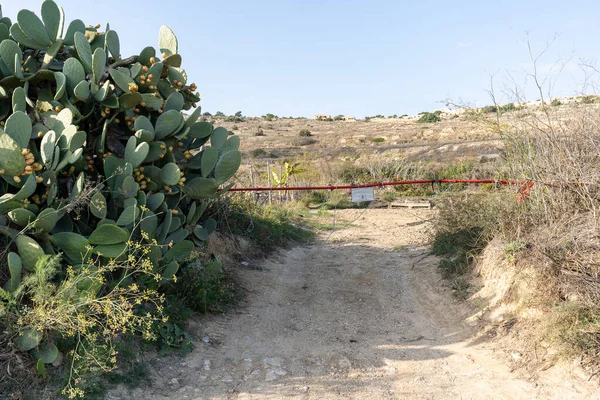 Boom barrier near path road. It is forbidden to enter the hills