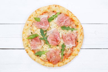 Ham pizza prosciutto from above on wooden board wood