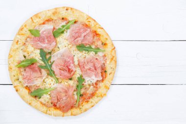 Ham pizza prosciutto from above copyspace copy space on wooden board wood